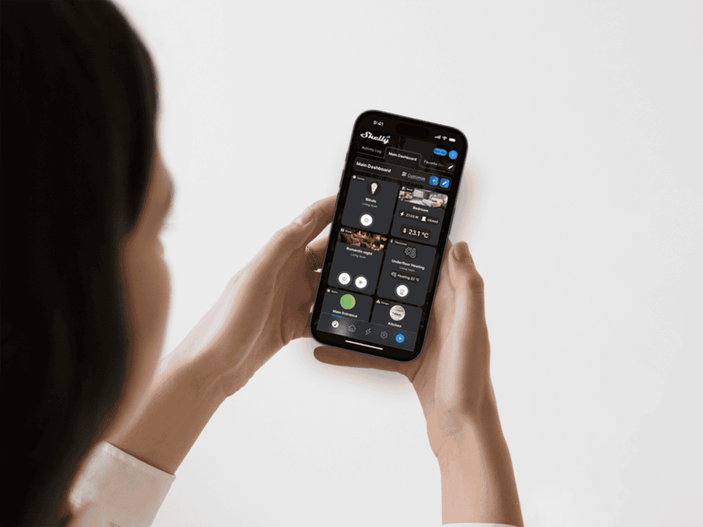Person holding a phone with the Shelly App running